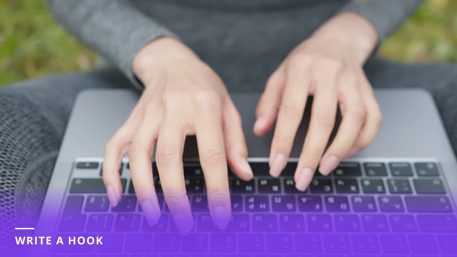 Professional woman typing a LinkedIn post on a laptop at a bright modern Western office desk, candid over-the-shoulder view with natural light.