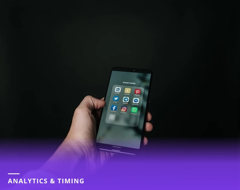 Close-up of hands holding a smartphone at a sunny morning cafe table, the phone screen displaying LinkedIn analytics graphs and engagement numbers, coffee cup blurred in background.