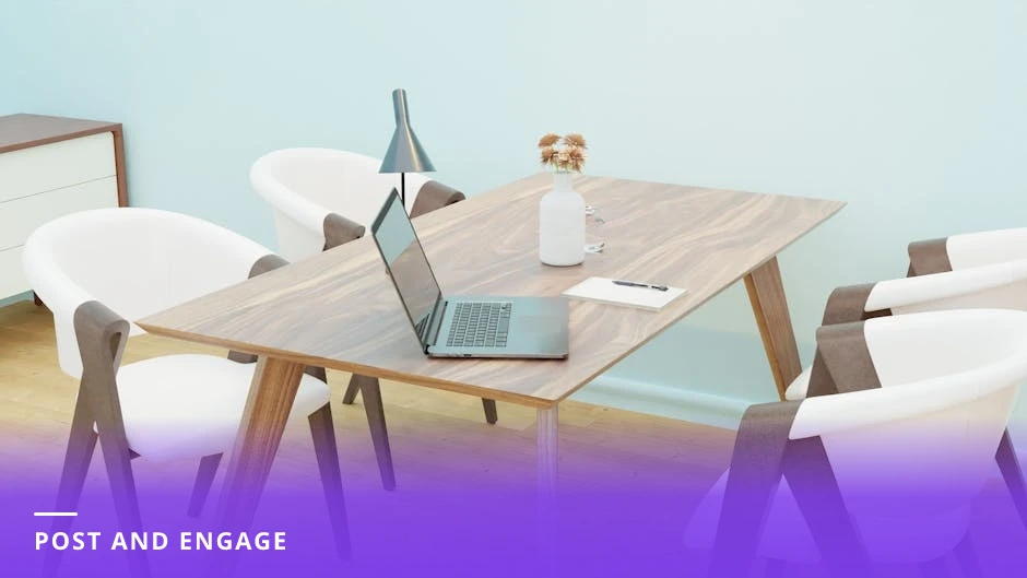 Professional woman at a bright Scandinavian office desk, typing on a laptop and looking at the screen while her phone beside her shows notification bubbles — actively responding to comments.