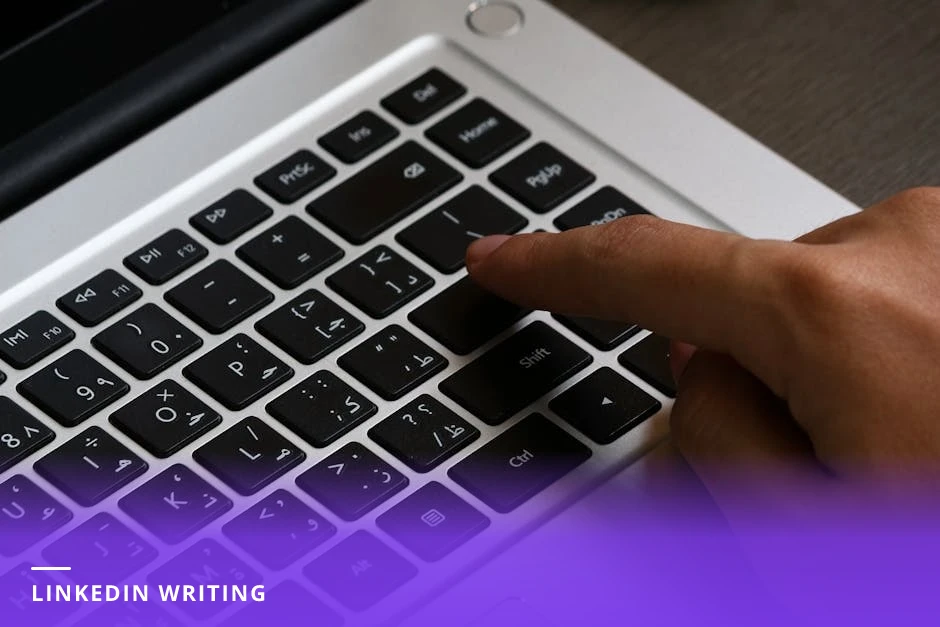 Mid-30s professional woman typing on a laptop in a sunlit modern Western workspace; smartphone and notebook nearby, focused expression, casual-professional clothing, natural light.
