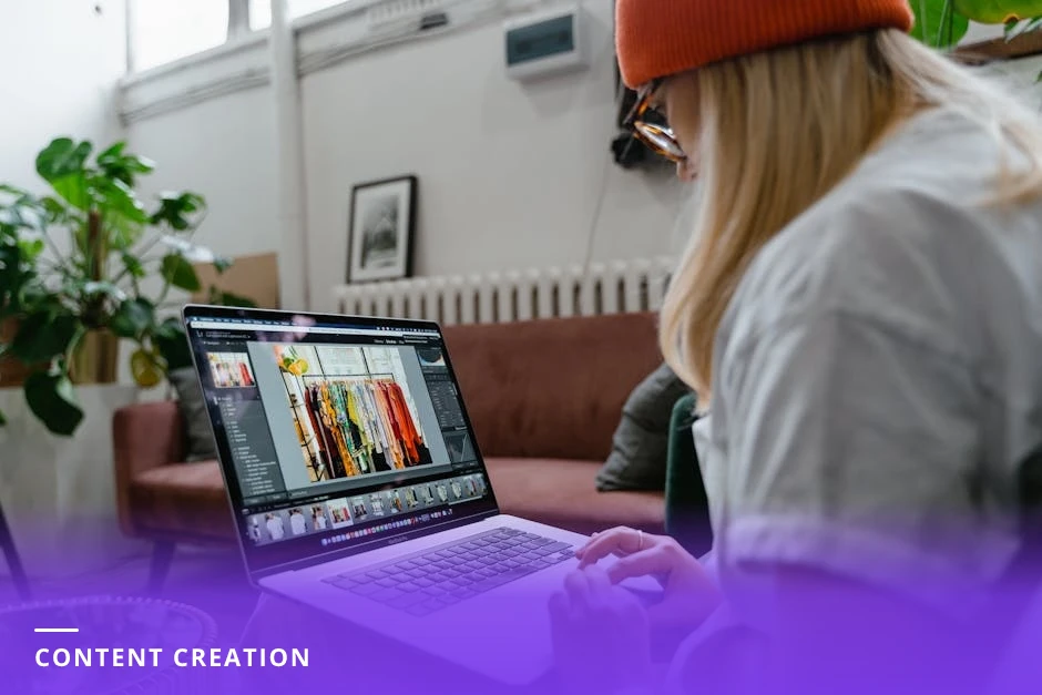 A young professional at a clean Scandinavian desk designing a LinkedIn carousel on a laptop, sketching slides on paper with a coffee cup and plants, soft natural light.