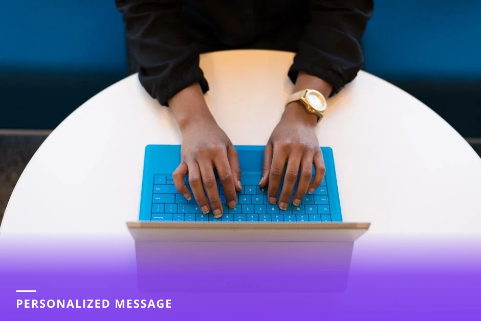 Career coach in a bright modern Western office typing a short personalized message on a laptop, with notebook and coffee on desk.
